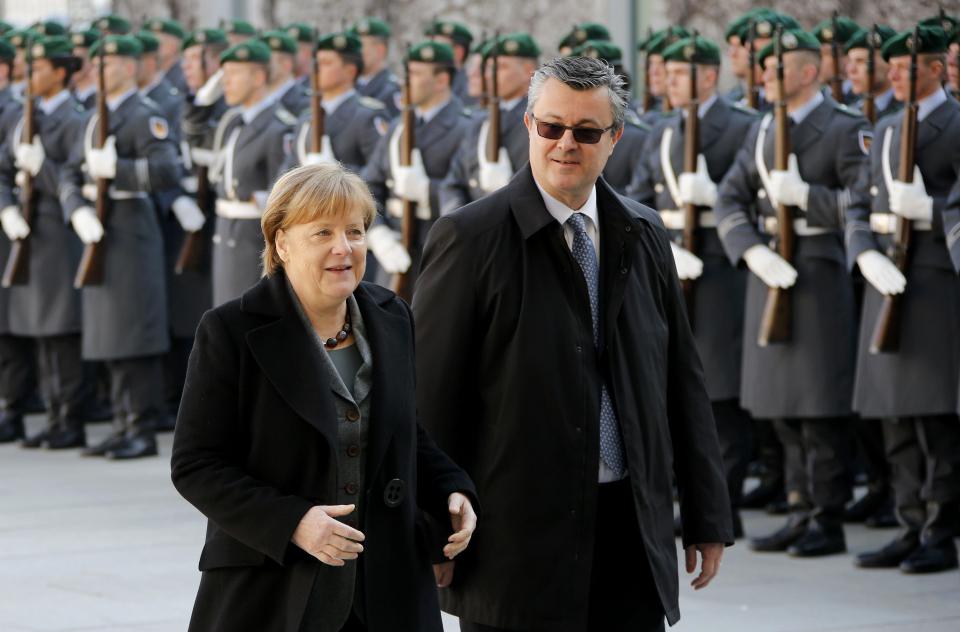 Croatian Prime Minister Tihomir Oreskovics (R) and German Chancellor Angela Merkel inspect the guard of honour during a ceremony at the Chancellery in Berlin, Germany, March 1, 2016. REUTERS/Fabrizio Bensch