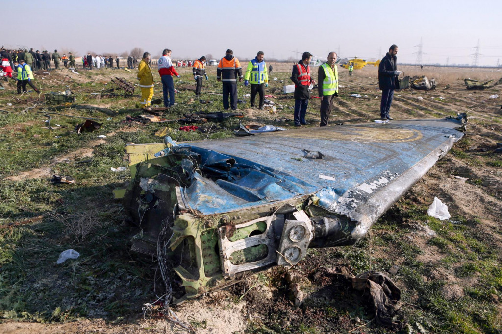 (FILES) In this file photo taken on January 8, 2020 rescue teams are seen at the scene of a Ukrainian airliner that crashed shortly after take-off near Imam Khomeini airport in the Iranian capital Tehran. - Iran said on January 11 that it unintentionally shot down the Ukrainian plane due to &amp;#39;human error&amp;#39;. (Photo by Akbar TAVAKOLI/IRNA/AFP)
