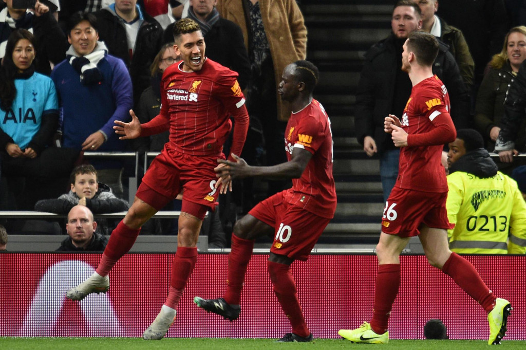 Liverpool&amp;#39;s Brazilian midfielder Roberto Firmino (L) celebrates scoring the opening goal during the English Premier League football match between Tottenham Hotspur and Liverpool at Tottenham Hotspur Stadium in London, on January 11, 2020. (Photo by Glyn KIRK/AFP)/RESTRICTED TO EDITORIAL USE. No use with unauthorized audio, video, data, fixture lists, club/league logos or &amp;#39;live&amp;#39; services. Online in-match use limited to 120 images. An additional 40 images may be used in extra time. No video emulation. Social media in-match use limited to 120 images. An additional 40 images may be used in extra time. No use in betting publications, games or single club/league/player publications./