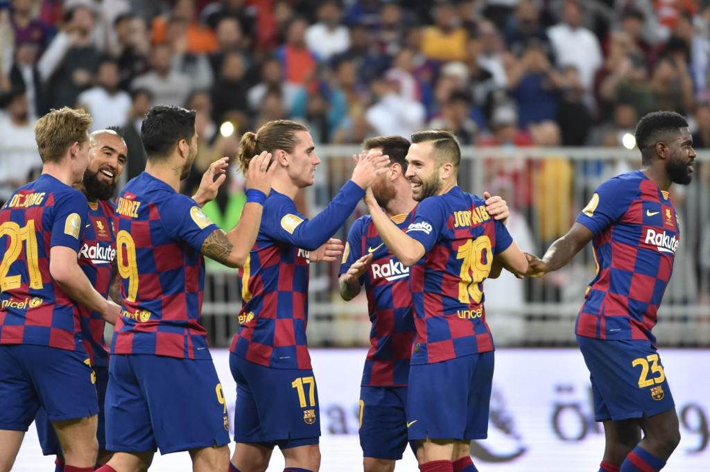 Barcelona&amp;#39;s players celebrate their goal during the Spanish Super Cup semi final between Barcelona and Atletico Madrid on January 9, 2020, at the King Abdullah Sport City in the Saudi Arabian port city of Jeddah. - The winner will face Real Madrid in the final on January 12. (Photo by FAYEZ NURELDINE/AFP)