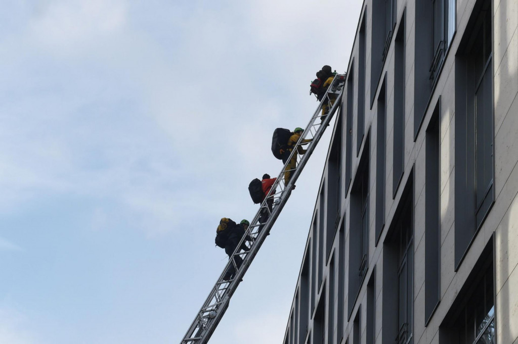 Activists from Greenpeace environmental organisation climb on top of the German industrial giant Siemens headquarters during an action to protest against a coal mining project in Australia, on the eve of Siemens&amp;#39; annual shareholders&amp;#39; meeting in Munich, on February 4, 2020. (Photo by Christof STACHE/AFP)