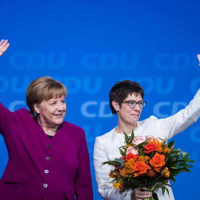 (FILES) This file photo taken on February 26, 2018 shows then Saarland&amp;#39;s State Premier and politician of the Christian Democratic Union (CDU) Annegret Kramp-Karrenbauer (R) and German Chancellor Angela Merkel standing on the stage after Kramp-Karrenbauer was elected new secretary general of the party during the CDU&amp;#39;s party congress in Berlin. - Annegret Kramp-Karrenbauer, the woman widely seen as German Chancellor Angela Merkel&amp;#39;s chosen successor, will not lead her crisis-racked CDU party into upcoming elections, a party source told AFP on February 10, 2020. (Photo by Stefanie LOOS/AFP)