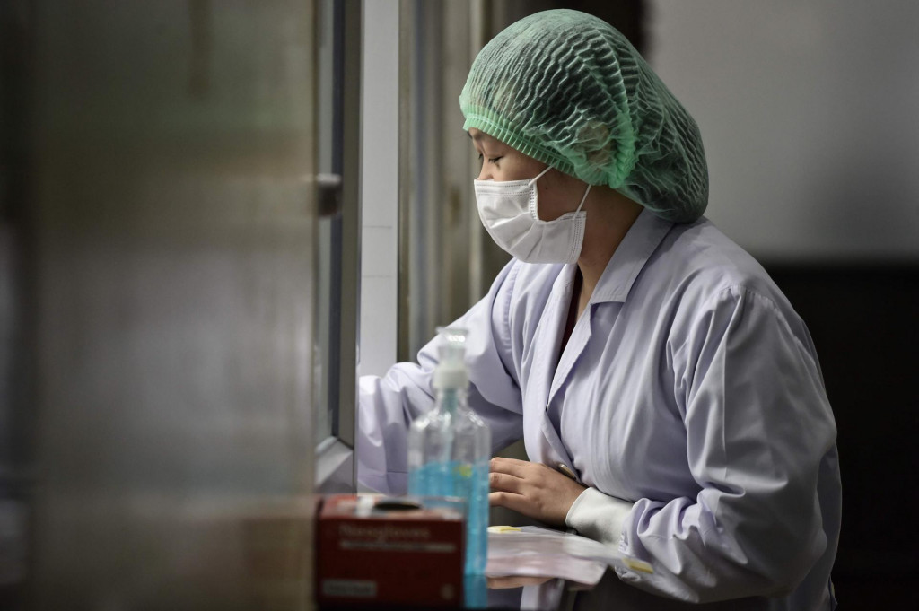 A lab technician registers samples from potential victims of the novel coronavirus at the Centre for Emerging Infectious Diseases of Thailand at Chulalongkorn University in Bangkok on February 5, 2020. - Thailand so far has detected 25 confirmed cases of the novel coronavirus believed to have originated in the central Chinese city of Wuhan, which is under lockdown. (Photo by Lillian SUWANRUMPHA/AFP)