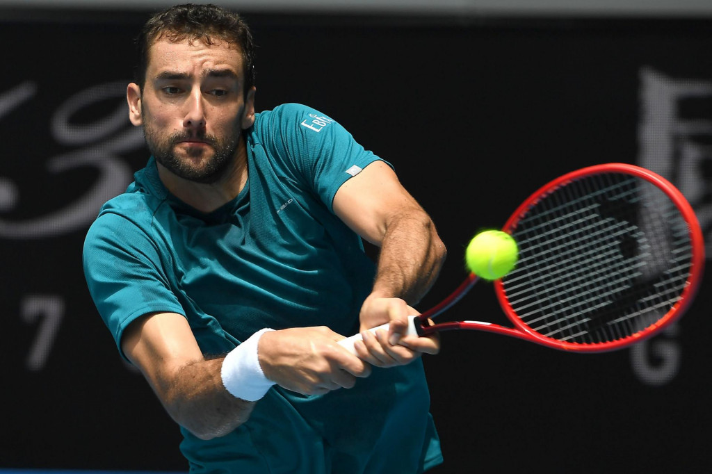 Croatia&amp;#39;s Marin Cilic hits a return against Canada&amp;#39;s Milos Raonic during their men&amp;#39;s singles match on day seven of the Australian Open tennis tournament in Melbourne on January 26, 2020. (Photo by Greg Wood/AFP)/IMAGE RESTRICTED TO EDITORIAL USE - STRICTLY NO COMMERCIAL USE