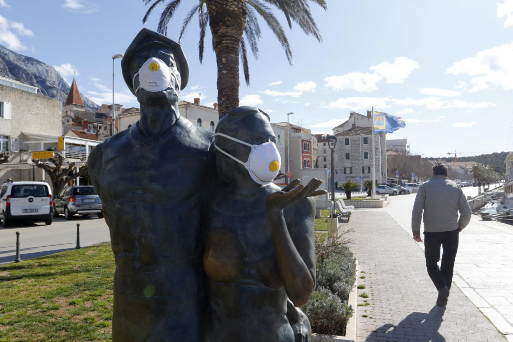 Skulptura U korak s vremenom, poznatija kao Spomenik turizmu opremljena zastitnim maskama