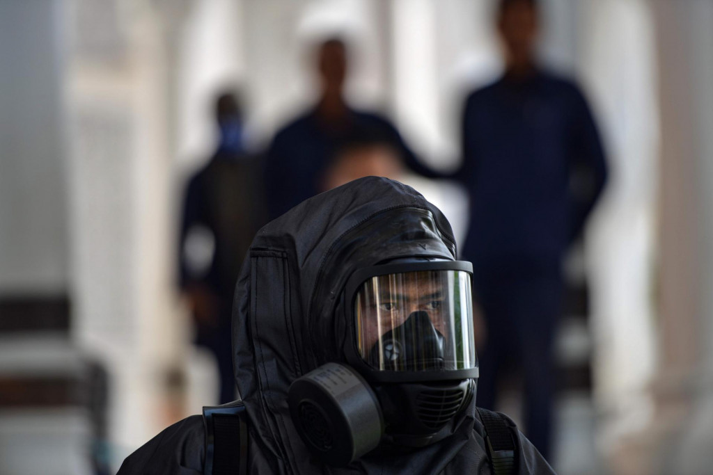 An Indonesian police officer prepares to spray disinfectant in the Baiturrahman grand mosque, amid concerns of the COVID-19 coronavirus, in Banda Aceh on March 20, 2020. (Photo by CHAIDEER MAHYUDDIN/AFP)