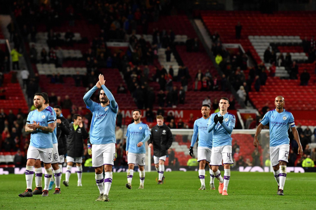 Manchester City&amp;#39;s German midfielder Ilkay Gundogan (2L) applauds the fans following the English League Cup semi-final first leg football match between Manchester United and Manchester City at Old Trafford in Manchester, north west England on January 7, 2020. - Manchester City won the match 3-1. (Photo by Paul ELLIS/AFP)/RESTRICTED TO EDITORIAL USE. No use with unauthorized audio, video, data, fixture lists, club/league logos or &amp;#39;live&amp;#39; services. Online in-match use limited to 75 images, no video emulation. No use in betting, games or single club/league/player publications./