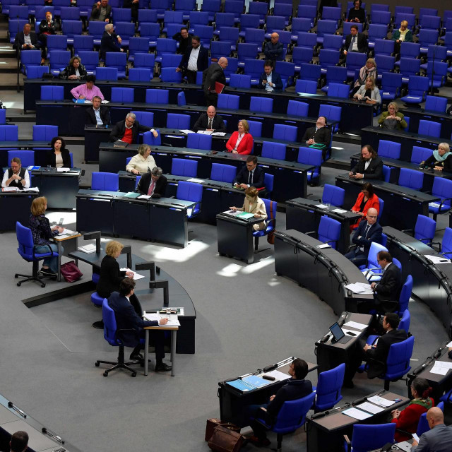 German Economy Minister Peter Altmaier (L) speaks to delegates practicing social distancing during a session at the Bundestag, Germany&amp;#39;s lower house of parliament, in Berlin on March 25, 2020. - Only every third chair was available to the MP&amp;#39;s in the chamber to mainitain social distancing during the debate as Germany enforces a partial lockdown trying to slow down the spread of the novel coronavirus that can cause the Covid-19 disease. (Photo by Tobias SCHWARZ/AFP)