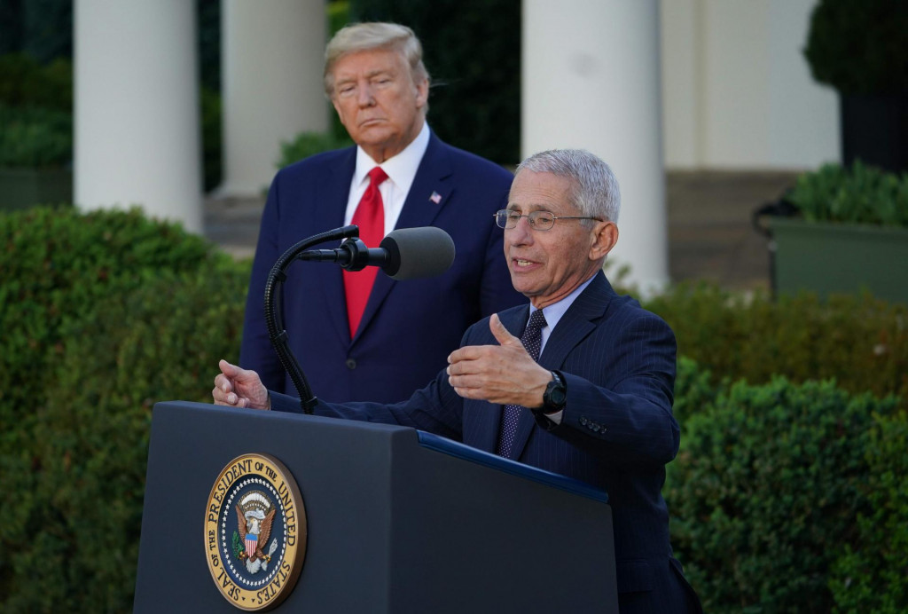 US President Donald Trump listens as Director of the National Institute of Allergy and Infectious Diseases Dr. Anthony Fauci speaks during a Coronavirus Task Force press briefing in the Rose Garden of the White House in Washington, DC, on March 30, 2020. 