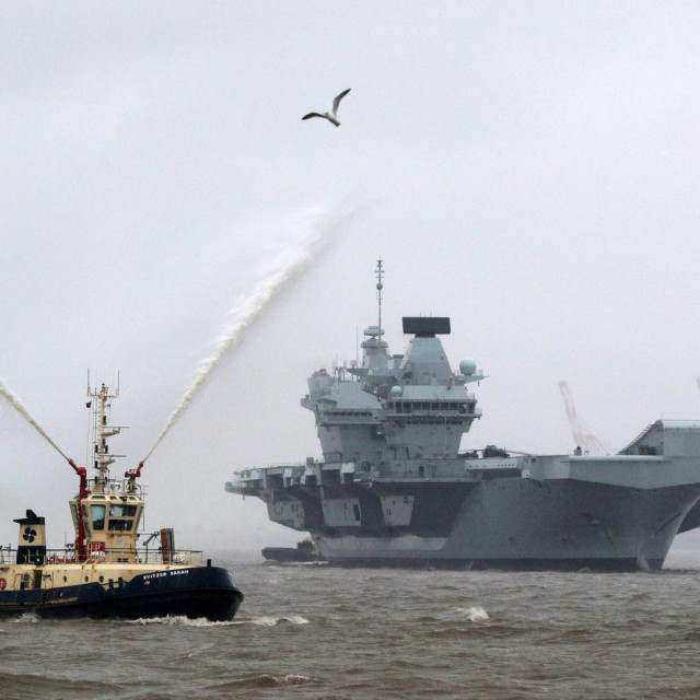 Tug boats manouevre Britain&amp;#39;s Royal Navy&amp;#39;s QE Class aircraft carrier the HMS Prince of Wales as it prepares to moor on the River Mersey, in front of the Liver Building in Liverpool, north-west England on February 28, 2020. - HMS Prince of Wales, is the the second of the Royal Navy&amp;#39;s QE Class aircraft carriers, built by the Aircraft Carrier Alliance. (Photo by Peter Byrne/POOL/AFP)