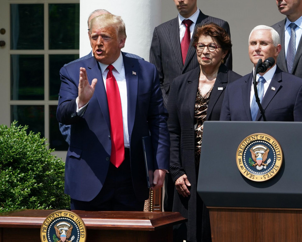 US President Donald Trump, with US Vice President Mike Pence (R), speaks after signing the Paycheck Protection Program Flexibility Act of 2020, during a press conference on the economy, in the Rose Garden of the White House in Washington, DC, on June 5, 2020. - The US economy regained 2.5 million jobs in May as coronavirus pandemic shutdowns began to ease, sending the unemployment rate falling to 13.3 percent, the Labor Department reported on June 5. (Photo by MANDEL NGAN/AFP)
