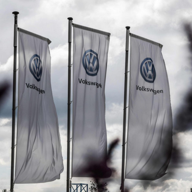 The logo of German car maker Volkswagen (VW) is seen on flags fluttering in front of a car dealer in Hamm, western Germany on May 25, 2020. - Judges at the Federal Court of Justice (BGH) ruled Monday, May 25, 2020 that Volkswagen must buy back a diesel car it modified to appear less polluting, a decision that could influence outcomes in thousands of other ”Dieselgate” cases. (Photo by Ina FASSBENDER/AFP)