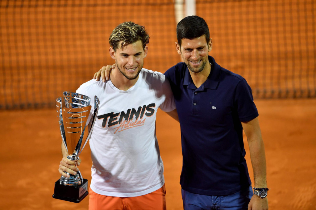 Austrian tennis player Dominic Thiem poses for a photo with Serbian tennis player Novak Djokovic after winning the final match against Serbian tennis player Filip Krajinovic at the Adria Tour