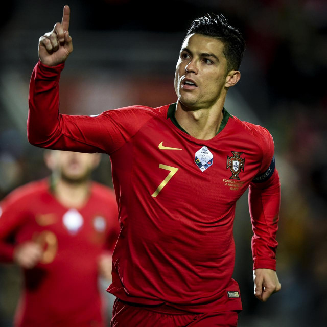 Portugal&amp;#39;s forward Cristiano Ronaldo celebrates after scoring a penalty during the Euro 2020 Group B football qualification match between Portugal and Lithuania at the Algarve stadium in Faro, on November 14, 2019. (Photo by PATRICIA DE MELO MOREIRA/AFP)