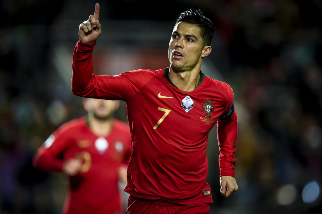 Portugal&amp;#39;s forward Cristiano Ronaldo celebrates after scoring a penalty during the Euro 2020 Group B football qualification match between Portugal and Lithuania at the Algarve stadium in Faro, on November 14, 2019. (Photo by PATRICIA DE MELO MOREIRA/AFP)