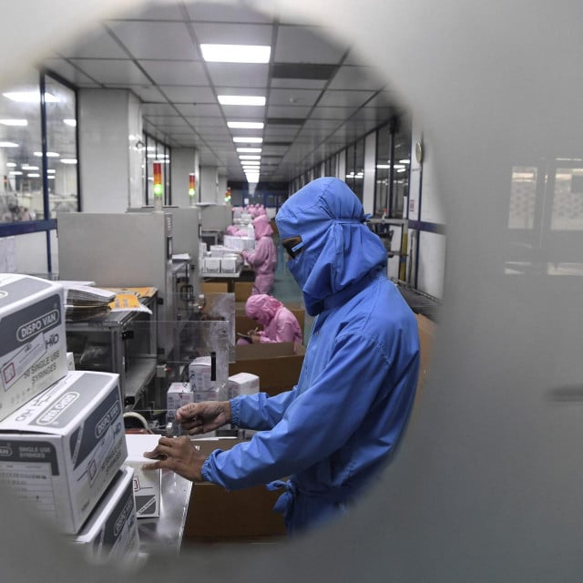 In this photograph taken on September 2, 2020, workers pack syringes at the Hindustan Syringes factory in Faridabad. - India&amp;#39;s biggest syringe manufacturer is ramping up its production to churn out a billion units, anticipating a surge in demand as the global race to find a COVID-19 coronavirus vaccine heats up. (Photo by SAJJAD HUSSAIN/AFP)