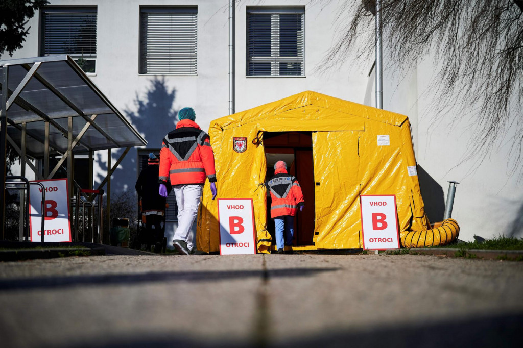 Medical workers walk in front of one of the entrances of the Community Health Centre in Kranj, Slovenia, on March 23, 2020 amid concerns over the spread of the COVID-19 coronavirus. (Photo by Jure Makovec/AFP)