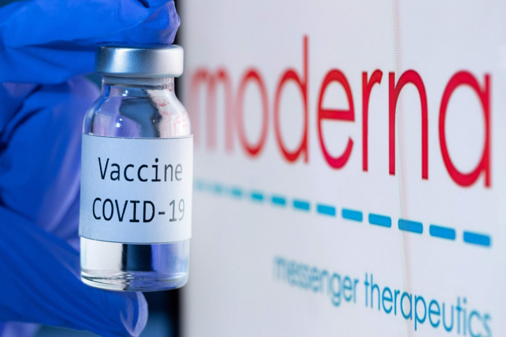 (FILES) In this file photo taken on November 18, 2020 shows a bottle reading ”Vaccine Covid-19” next to the Moderna biotech company logo. - US firm Moderna said it would file requests for emergency authorization of its Covid-19 vaccine in the United States and Europe on November 30, 2020, after full results confirmed a high efficacy estimated at 94.1 percent. ”We believe that our vaccine will provide a new and powerful tool that may change the course of this pandemic and help prevent severe disease, hospitalizations and death,” said the company&amp;#39;s CEO Stephane Bancel. (Photo by JOEL SAGET/AFP)/-- IMAGE RESTRICTED TO EDITORIAL USE - STRICTLY NO COMMERCIAL USE --
