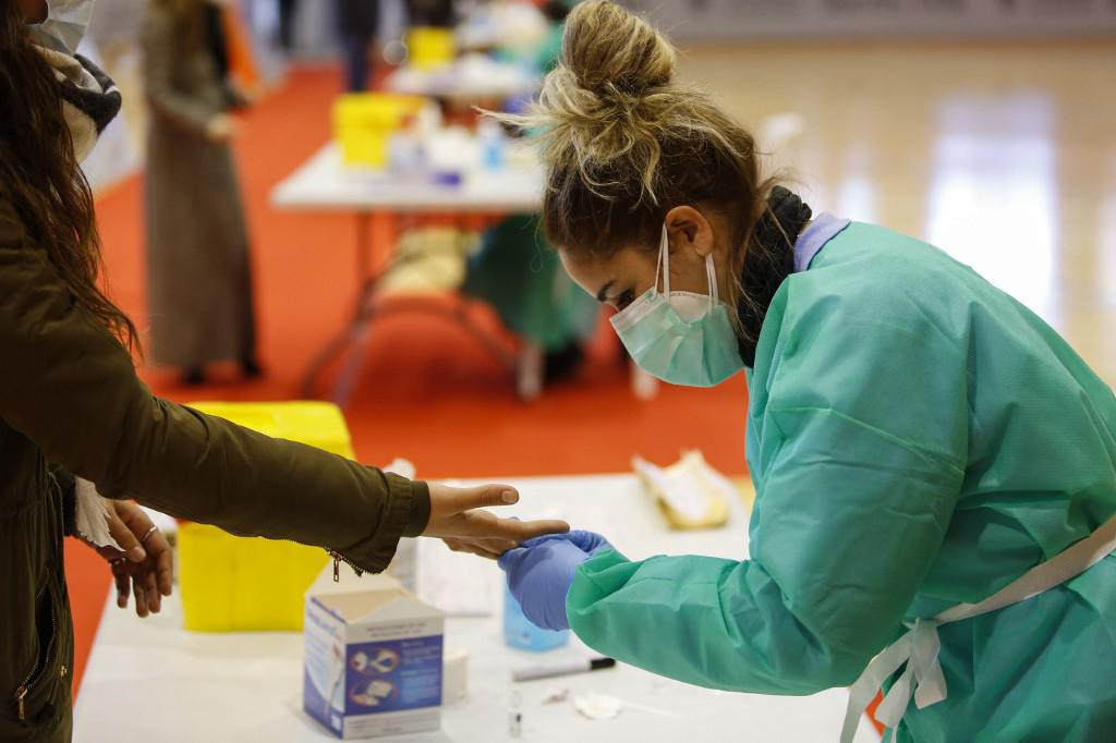 A health worker in a protective suit taking a blood sample during a massive coronavirus antigen testing for teachers and education workers on January 04, 2021 in Granada, Spain.&lt;br /&gt;
(Photo by Álex Cámara/NurPhoto)