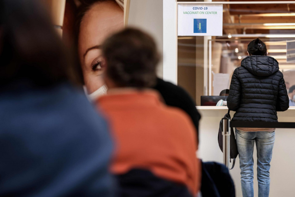 People queue to receive an injection of the Moderna Covid-19 vaccine at the first Covid-19 vaccination center in Belgium on February 2, 2020 in Brussels, amid the crisis linked with the Covid-19 pandemic caused by the novel coronavirus. (Photo by Kenzo TRIBOUILLARD/AFP)