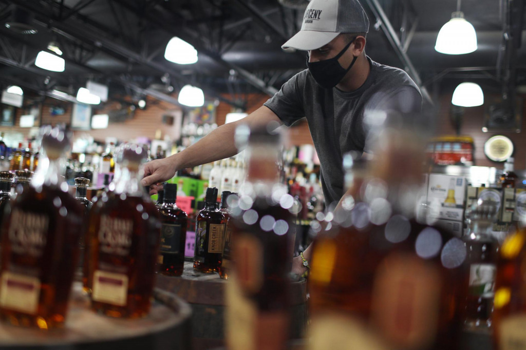 MIAMI, FLORIDA - FEBRUARY 03: Javier Ruis stocks liquor at Jensen&amp;#39;s Liquors on February 03, 2021 in Miami, Florida. The Distilled Spirits Council reported that U.S. distillers� revenue grew 7.7% to $31.2 billion last year, marking the fastest growth and highest sales for at least 40 years. Alcohol that sold for above $40 per 750 milliliters accounted for 40% of the U.S. spirits industry�s growth in 2020, compared with 34% in 2019. Joe Raedle/Getty Images/AFP&lt;br /&gt;
== FOR NEWSPAPERS, INTERNET, TELCOS &amp; TELEVISION USE ONLY ==