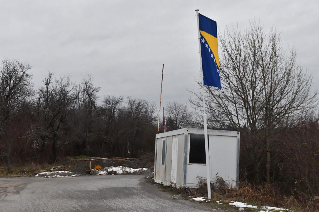 This picture taken on January 30, 2021, shows police containers at blocked-off crossing on Bosnia - Croatia border in the northern-bosnian village of Bosanska Bojna. - Bosanska Bojna is mostly unpopulated village, with war damaged houses and homesteads, abandoned by their Bosnian-Serb owners, after Bosnia&amp;#39;s 1992-95 war, near town of Velika Kladusa, in Northern Bosnia. In present times the village is frequented by illegal migrants from Asia, in their atempts to cross the border, on their way towards the Western-European countries. Due to police push-backs by Croatian border police, some migrant families inhabit abandoned houses in Bosanska Bojna, to remain closer to the border and prepare for further atempts to cross the closely guarded EU border. (Photo by ELVIS BARUKCIC/AFP)