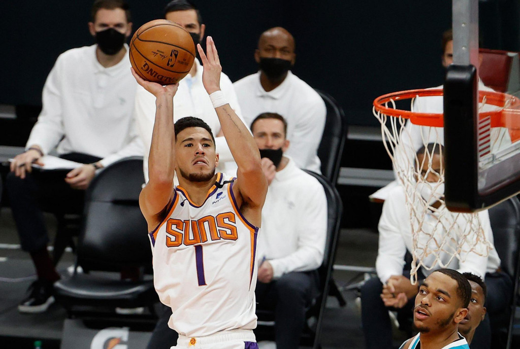 PHOENIX, ARIZONA - FEBRUARY 24: Devin Booker #1 of the Phoenix Suns attempts a shot over Cody Zeller #40 of the Charlotte Hornets during the second half of the NBA game at Phoenix Suns Arena on February 24, 2021 in Phoenix, Arizona. NOTE TO USER: User expressly acknowledges and agrees that, by downloading and or using this photograph, User is consenting to the terms and conditions of the Getty Images License Agreement. Christian Petersen/Getty Images/AFP&lt;br /&gt;
== FOR NEWSPAPERS, INTERNET, TELCOS &amp; TELEVISION USE ONLY ==