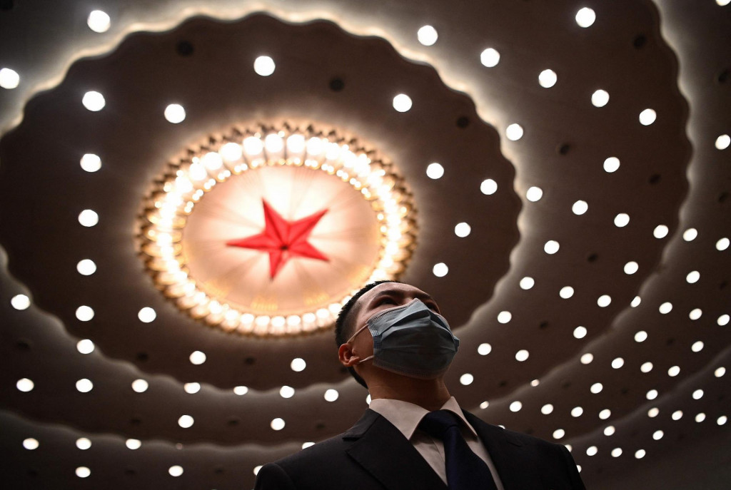 A security personnel watches on after the second plenary session of the National People�s Congress (NPC) at the Great Hall of the People in Beijing on March 8, 2021. (Photo by Noel Celis/AFP)