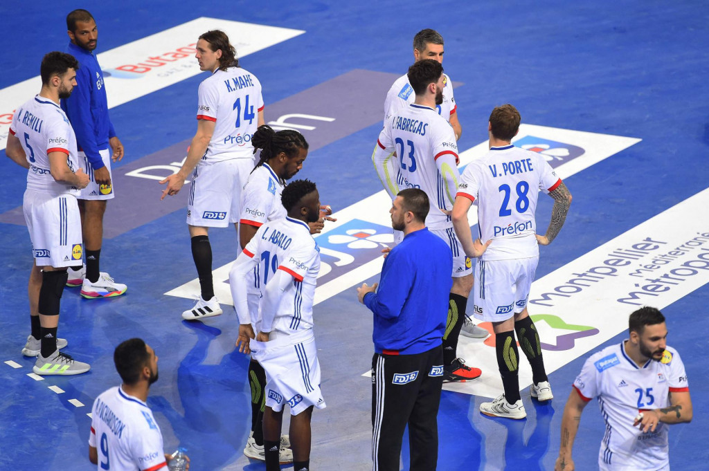 France&amp;#39;s team players react at the end of the IHF Men&amp;#39;s Tokyo Handball Qualification 2020 match between Portugal and France at the Sud de France Arena in Perols, southern France on March 14, 2021. (Photo by Sylvain THOMAS/AFP)