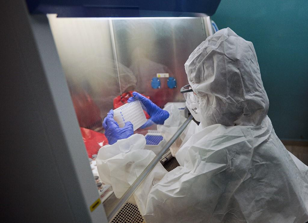 A technician of the Molecular Biology Laboratory of Villa Clara, in Cuba, analyzes PCR samples amid the novel coronavirus, COVID-19, pandemic, on April 25, 2021. (Photo by Yamil LAGE/AFP)