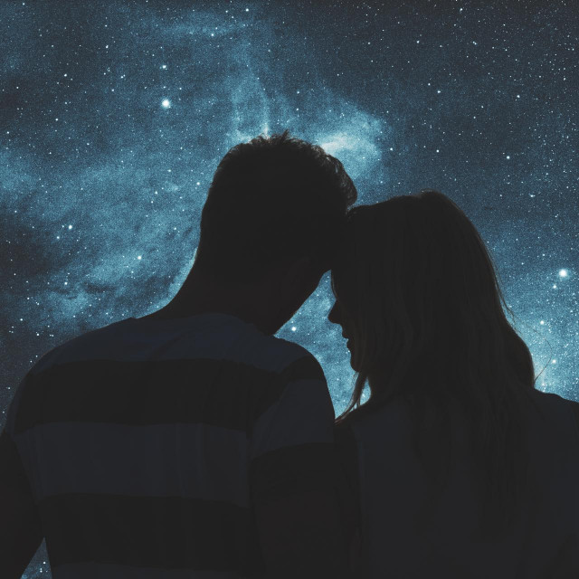 Silhouettes of a young couple under the starry sky. Elements of this image are my work.