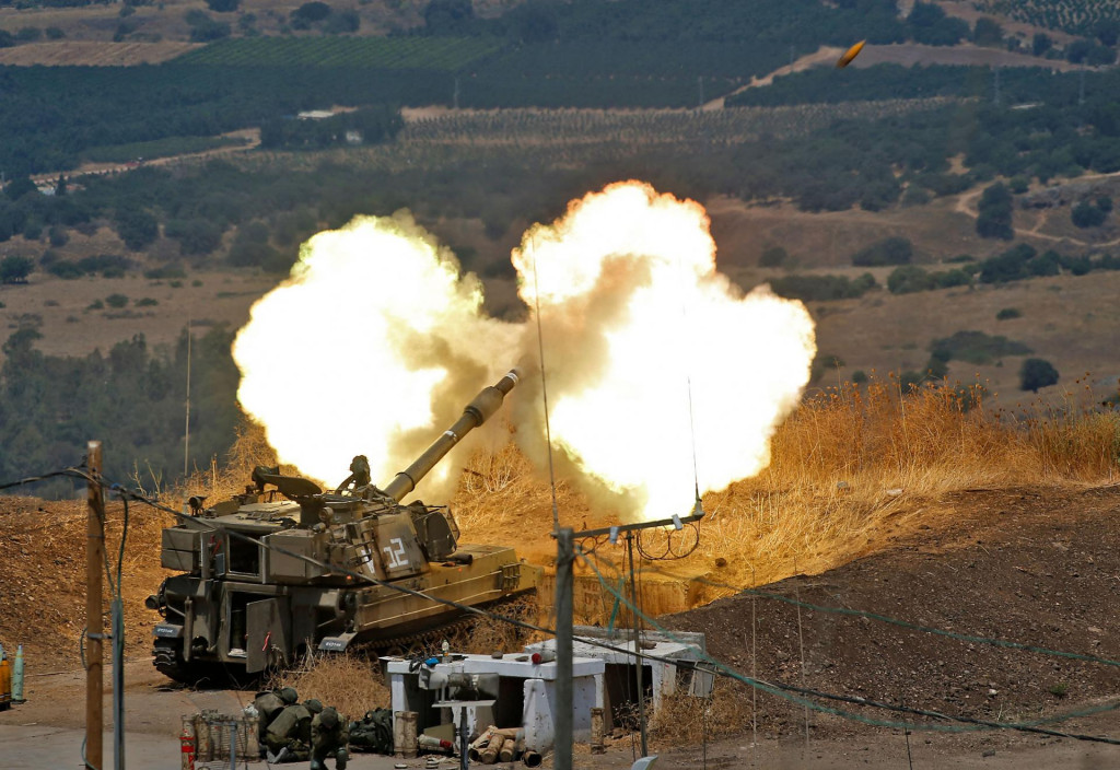 Israeli self-propelled howitzers fire towards Lebanon from a position near the northern Israeli town of Kir-yat Shmona following rocket fire from the Lebanese side of the border, on August 6, 2021. (Photo by JALAA MAREY/AFP)