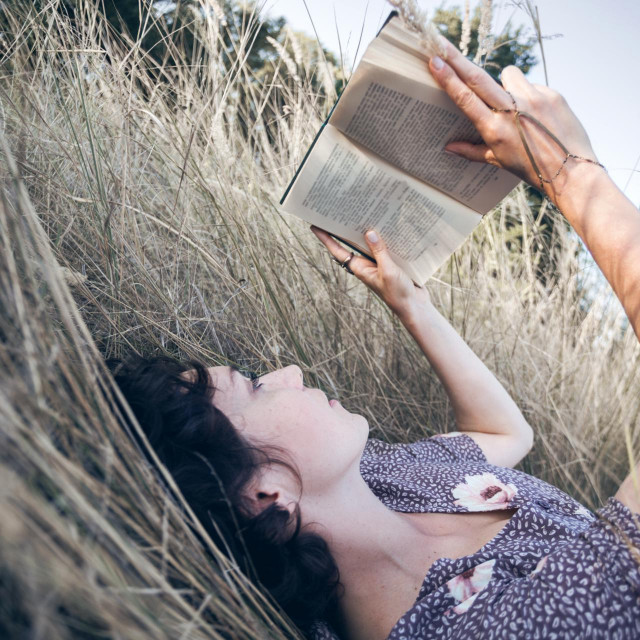 retro style. girl reads a book outdoors