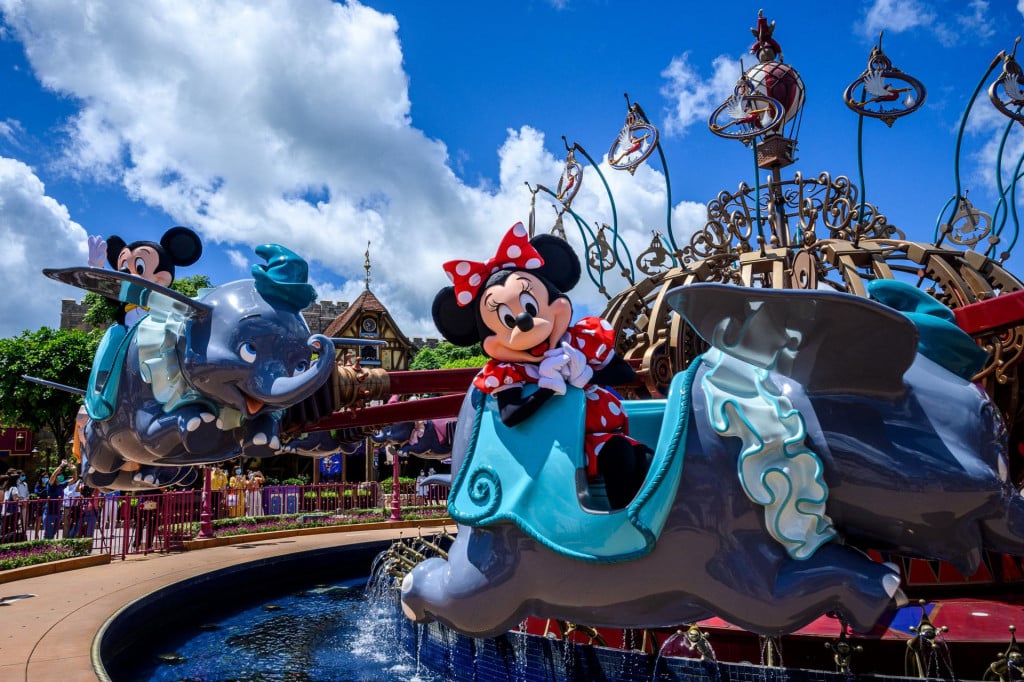 Cast members dressed as cartoon characters Minnie Mouse (R) and Mickey Mouse (L) sit on a ride as part of a publicity exercise for the media at Hong Kong&amp;#39;s Disneyland on June 17, 2020, a day before the theme park&amp;#39;s doors reopen following nearly five months of closure in a fresh boost for a city that has largely managed to defeat the COVID-19 coronavirus. - It is just the second Disneyland around the world to resume services during the pandemic after Shanghai turned its lights and rides back on last month. (Photo by Anthony WALLACE/AFP)