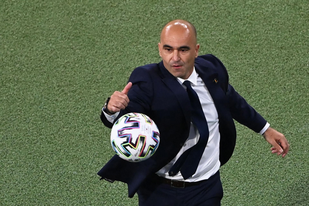 Belgium&amp;#39;s Spanish coach Roberto Martinez goes for the ball on the touchline during the UEFA EURO 2020 quarter-final football match between Belgium and Italy at the Allianz Arena in Munich on July 2, 2021. (Photo by STUART FRANKLIN/POOL/AFP)