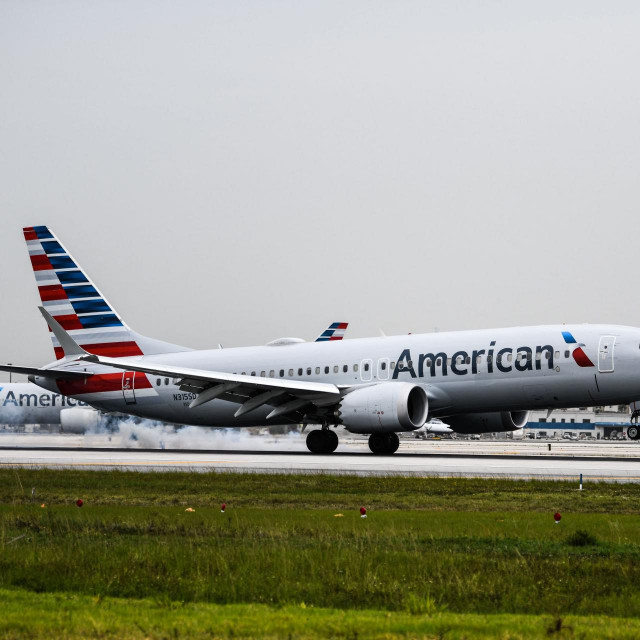 (FILES) In this file photo taken on June 16, 2021, an American Airlines plane lands at the Miami International Airport in Miami. - Several leading US airlines on September 9, 2021 cut their forecasts for the third quarter, citing lower bookings and increased cancelations due to the latest wave of Covid-19 infections. (Photo by CHANDAN KHANNA/AFP)