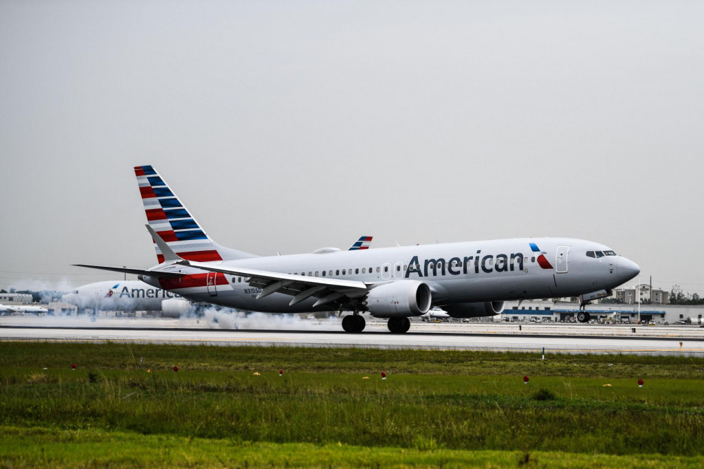 (FILES) In this file photo taken on June 16, 2021, an American Airlines plane lands at the Miami International Airport in Miami. - Several leading US airlines on September 9, 2021 cut their forecasts for the third quarter, citing lower bookings and increased cancelations due to the latest wave of Covid-19 infections. (Photo by CHANDAN KHANNA/AFP)