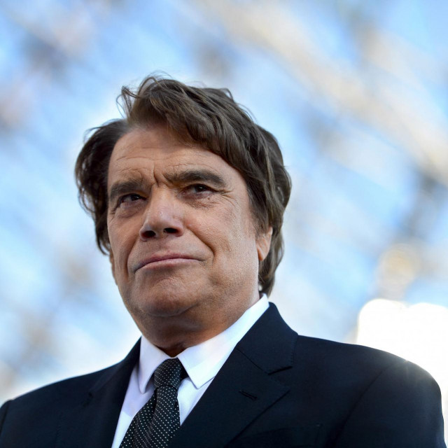 (FILES) In this file photograph taken on May 26, 2013, former president of Olympique de Marseille (OM) Bernard Tapie looks on before the start of the French L1 football match between Olympique de Marseille (OM) and Reims (SR) and the festivities marking the anniversary of OM&amp;#39;s 1993 UEFA Champions League title at The Velodrome Stadium in Marseille, southern France. - French businessman Bernard Tapie passed away at the age of 78, his family announced on October 3, 2021. (Photo by GERARD JULIEN/AFP)