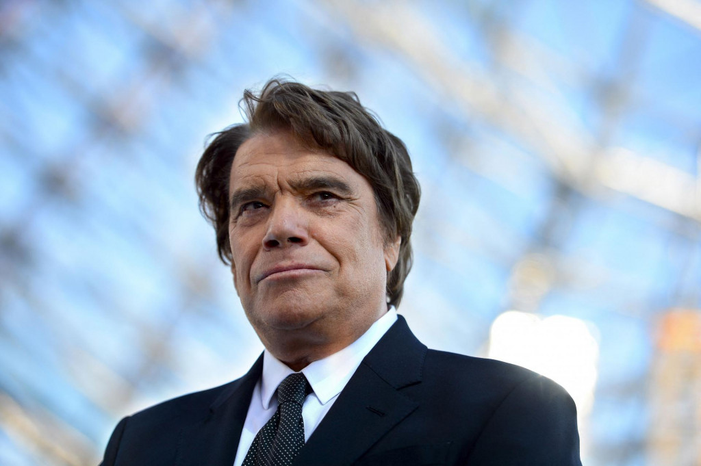 (FILES) In this file photograph taken on May 26, 2013, former president of Olympique de Marseille (OM) Bernard Tapie looks on before the start of the French L1 football match between Olympique de Marseille (OM) and Reims (SR) and the festivities marking the anniversary of OM&amp;#39;s 1993 UEFA Champions League title at The Velodrome Stadium in Marseille, southern France. - French businessman Bernard Tapie passed away at the age of 78, his family announced on October 3, 2021. (Photo by GERARD JULIEN/AFP)