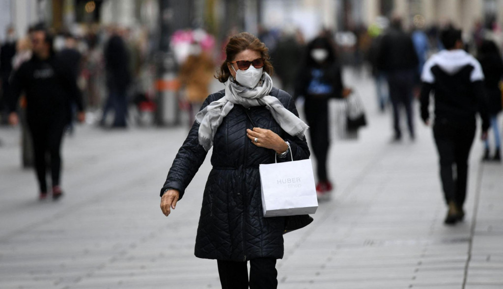 A woman walks with her purchases in the center of Vienna 