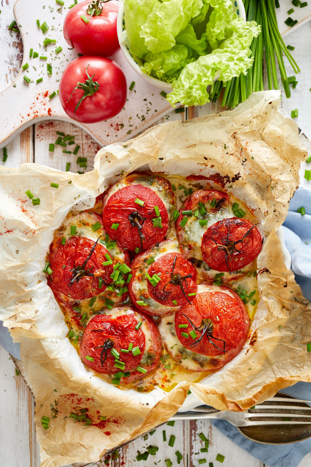 Oven baked tomatoes stuffed with spinach, mozzarella cheese and fresh chive, top view