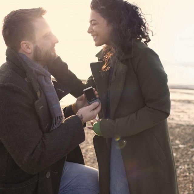 Boyfriend with ring proposing to girlfriend on winter beach. (Photo by Sam Edwards/CAIA IMAGE/SCIENCE P/NEW/Science Photo Library via AFP)
