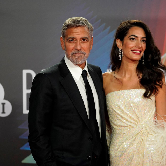 US actor George Clooney and his wife Lebanese-British barrister Amal Clooney pose on the red carpet on arrival to attend the UK premiere of the film &amp;#39;The Temple Bar&amp;#39;, during the 2021 BFI London Film Festival in London on October 10, 2021. (Photo by Niklas HALLE&amp;#39;N/AFP)
