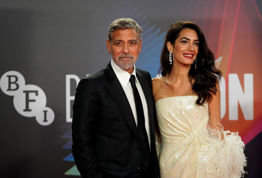 US actor George Clooney and his wife Lebanese-British barrister Amal Clooney pose on the red carpet on arrival to attend the UK premiere of the film &amp;#39;The Temple Bar&amp;#39;, during the 2021 BFI London Film Festival in London on October 10, 2021. (Photo by Niklas HALLE&amp;#39;N/AFP)