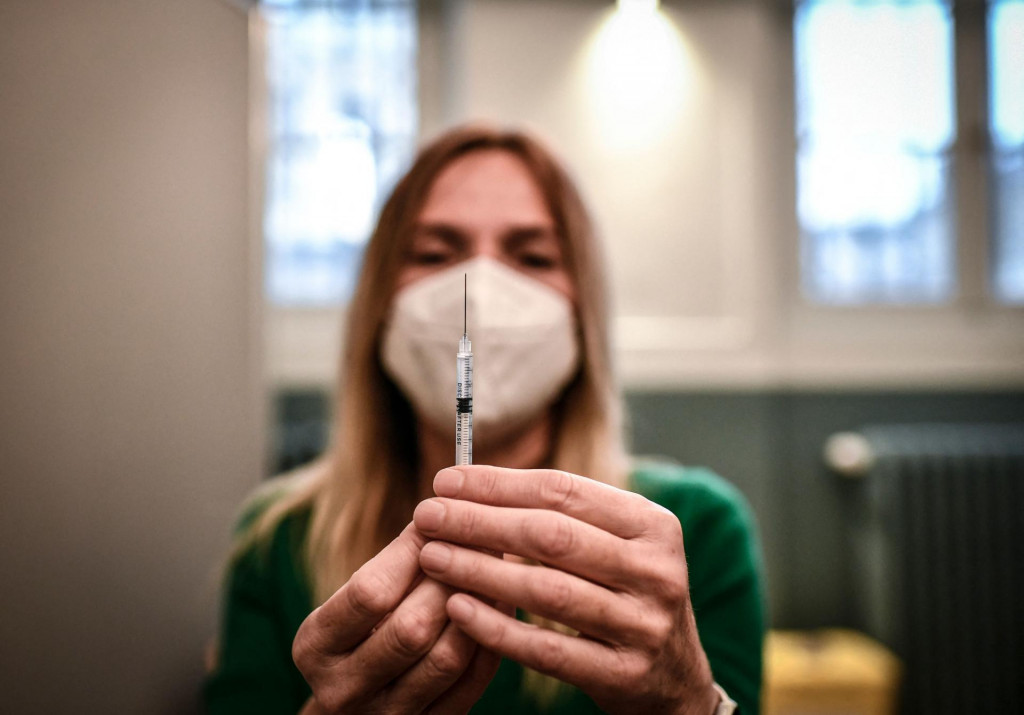 A medical staff member prepares a syringe with a dose of the Pfizer-BioNTech Covid-19 vaccine at a temporary vaccination centre in Paris, on November 27, 2021, amid the Covid-19 (novel coronavirus) pandemic. - France made Covid-19 booster shots available to all adults on November 25, 2021. (Photo by STEPHANE DE SAKUTIN/AFP)
