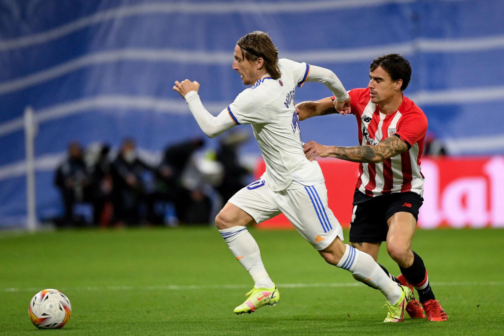 Real Madrid&amp;#39;s Croatian midfielder Luka Modric (L) fights for the ball with Athletic Bilbao&amp;#39;s Spanish midfielder Dani Garcia during the Spanish league football match between Real Madrid CF and Athletic Club Bilbao at the Santiago Bernabeu stadium in Madrid on December 1, 2021. (Photo by PIERRE-PHILIPPE MARCOU/AFP)