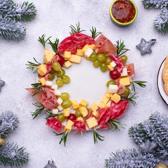 Festive snacks and appetizers plate in shape of Christmas wreath