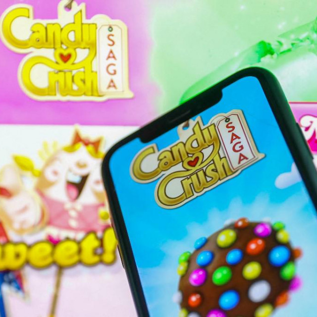Candy Crush Saga logo displayed on a phone screen and Candy Crush website displayed in the background is seen in this illustration photo taken in Krakow, Poland on January 23, 2022. (Photo by Jakub Porzycki/NurPhoto) (Photo by Jakub Porzycki/NurPhoto/NurPhoto via AFP)
