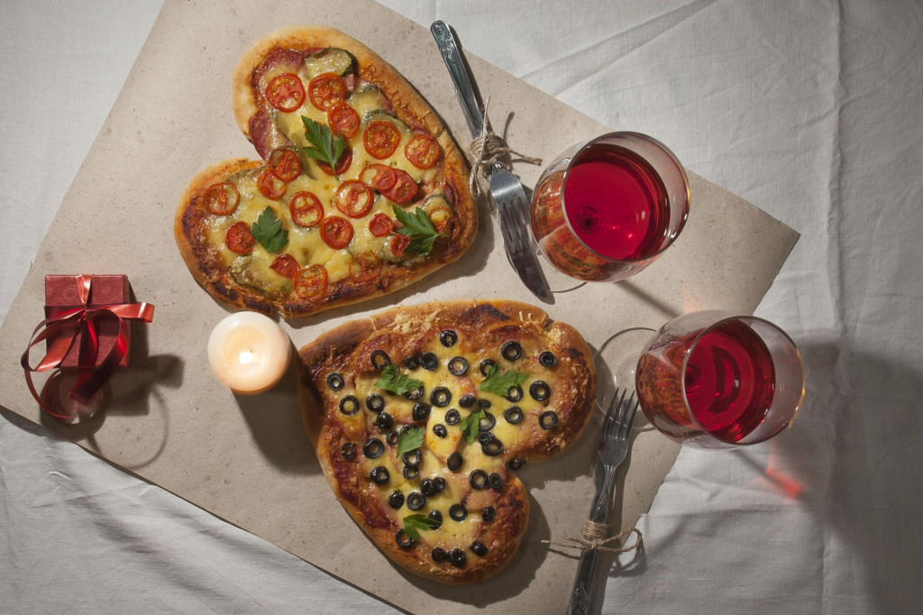 Romantic love heart shaped pizza dinner and giving gifts