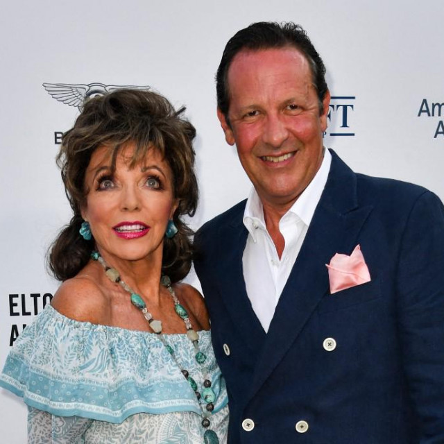 British actress Joan Collins and her husband Percy Gibson pose on the red carpet upon their arrival for the midsummer party for Elthon John AIDS Foundation, in Cap d&amp;#39;Antibes, near Antibes, southern France, on July 24, 2019. (Photo by Yann COATSALIOU/AFP)